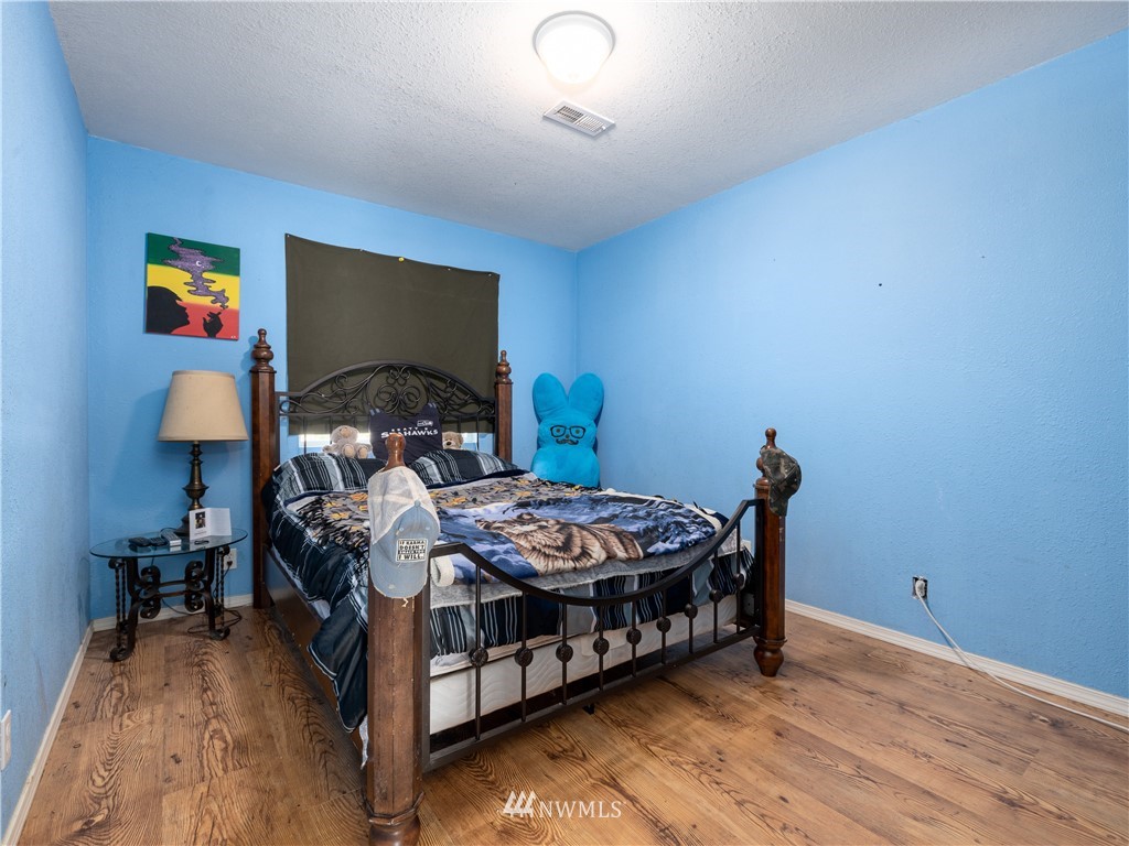 553 River Road Chehalis, WA 98532 - Photo 10 of 22 a bedroom with furniture and a wooden floor