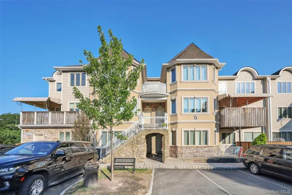 a front view of a residential apartment building with a yard