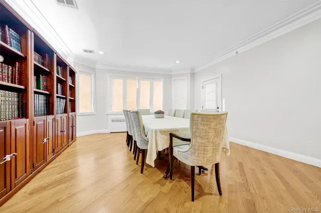 a view of a a dining room with furniture window and wooden floor