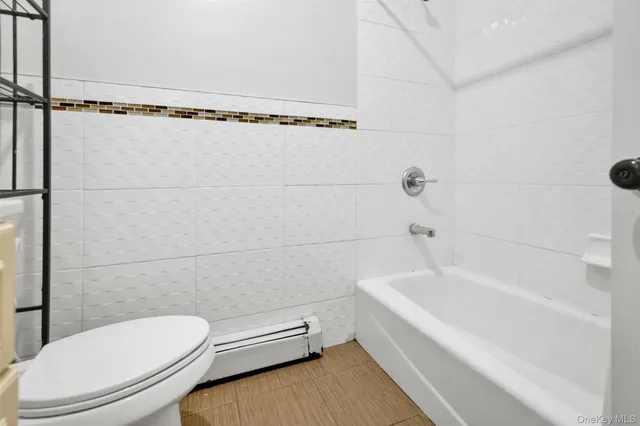 a bathroom with a toilet and a bathtub