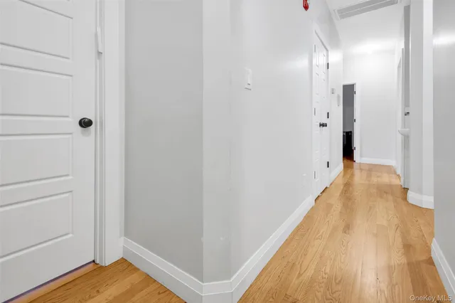 a view of a bedroom with wooden floor