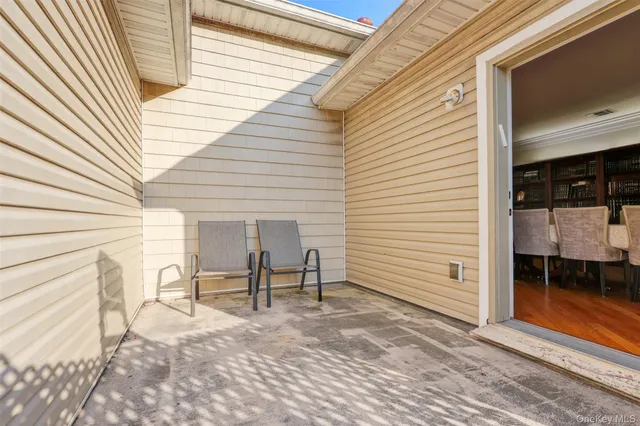 a view of a two chairs in the balcony