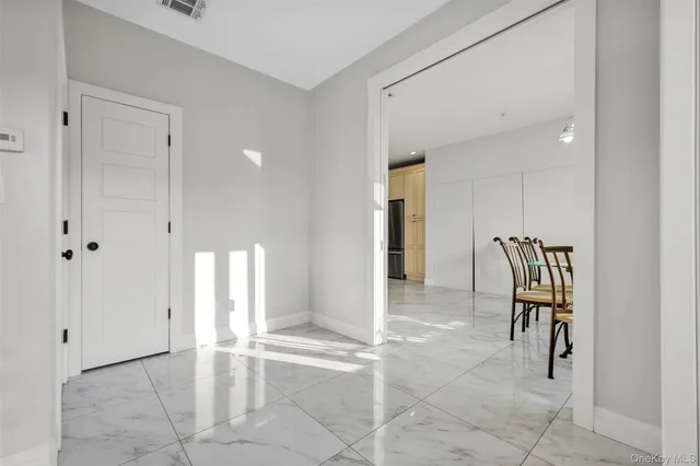 a view of kitchen with furniture and refrigerator