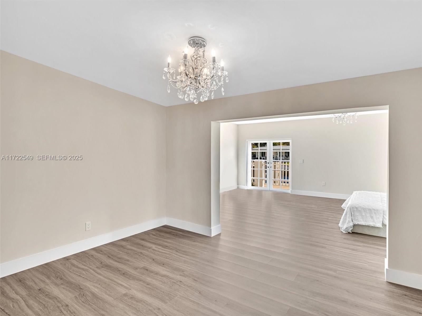 12904 Banyan Road North Miami, FL 33181 - Photo 37 of 87 a view of an empty room with wooden floor and a window