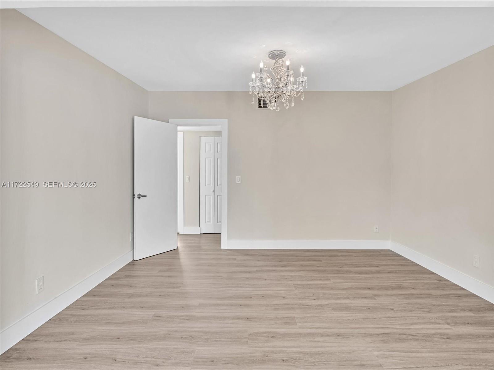 12904 Banyan Road North Miami, FL 33181 - Photo 52 of 87 a view of an empty room with wooden floor
