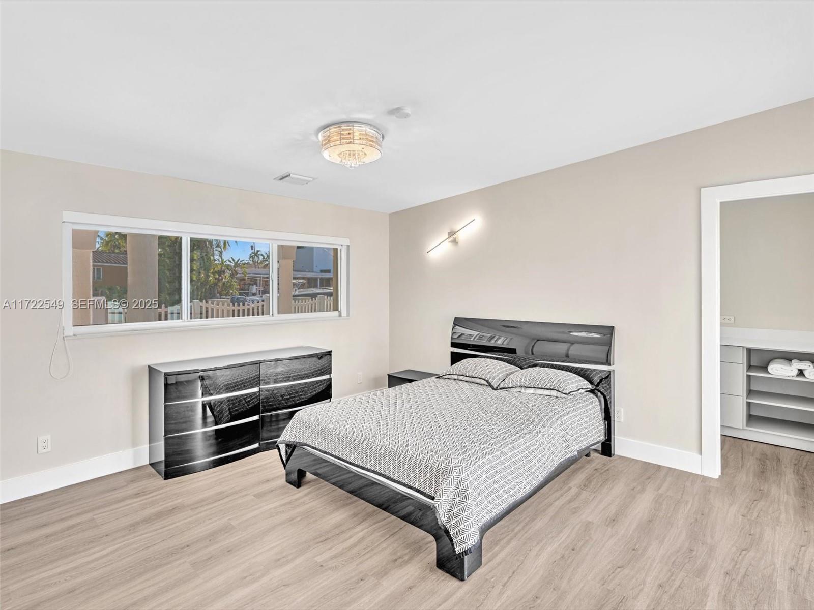 12904 Banyan Road North Miami, FL 33181 - Photo 54 of 87 a bedroom with a bed and wooden floor