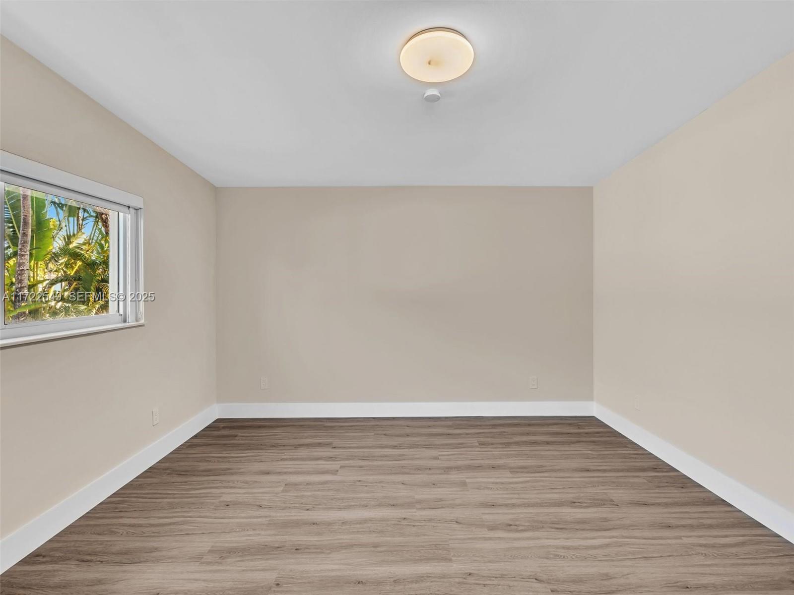 12904 Banyan Road North Miami, FL 33181 - Photo 62 of 87 a view of an empty room with wooden floor and a window