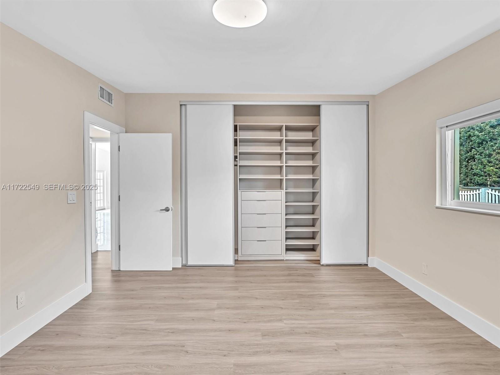 12904 Banyan Road North Miami, FL 33181 - Photo 64 of 87 a view of walk in closet with wooden floor