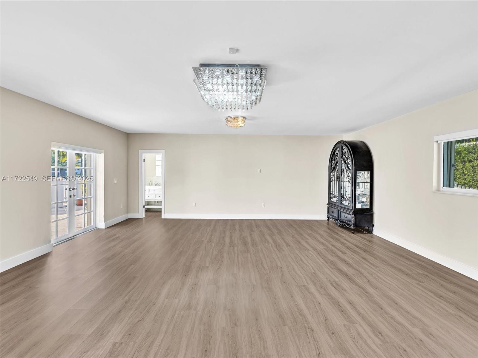 12904 Banyan Road North Miami, FL 33181 - Photo 76 of 87 an empty room with wooden floor and windows