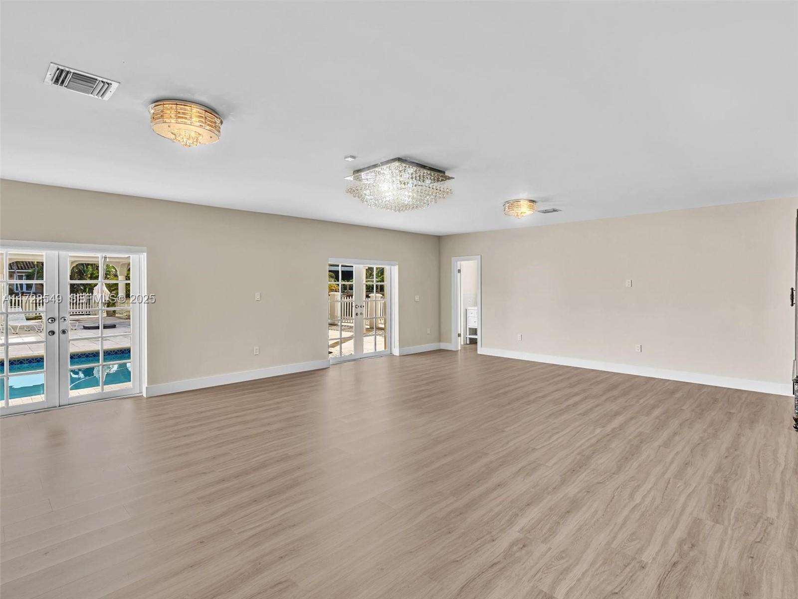 12904 Banyan Road North Miami, FL 33181 - Photo 77 of 87 a view of an empty room with wooden floor and a window