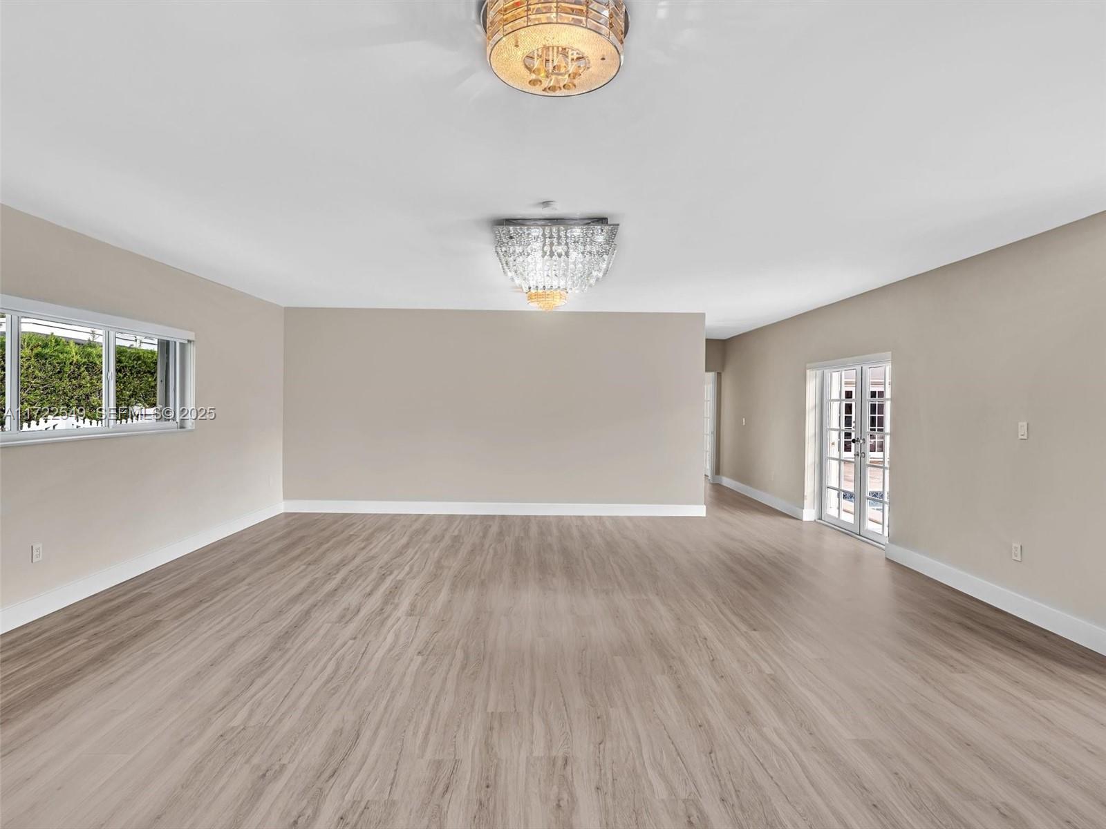 12904 Banyan Road North Miami, FL 33181 - Photo 78 of 87 an empty room with wooden floor and windows