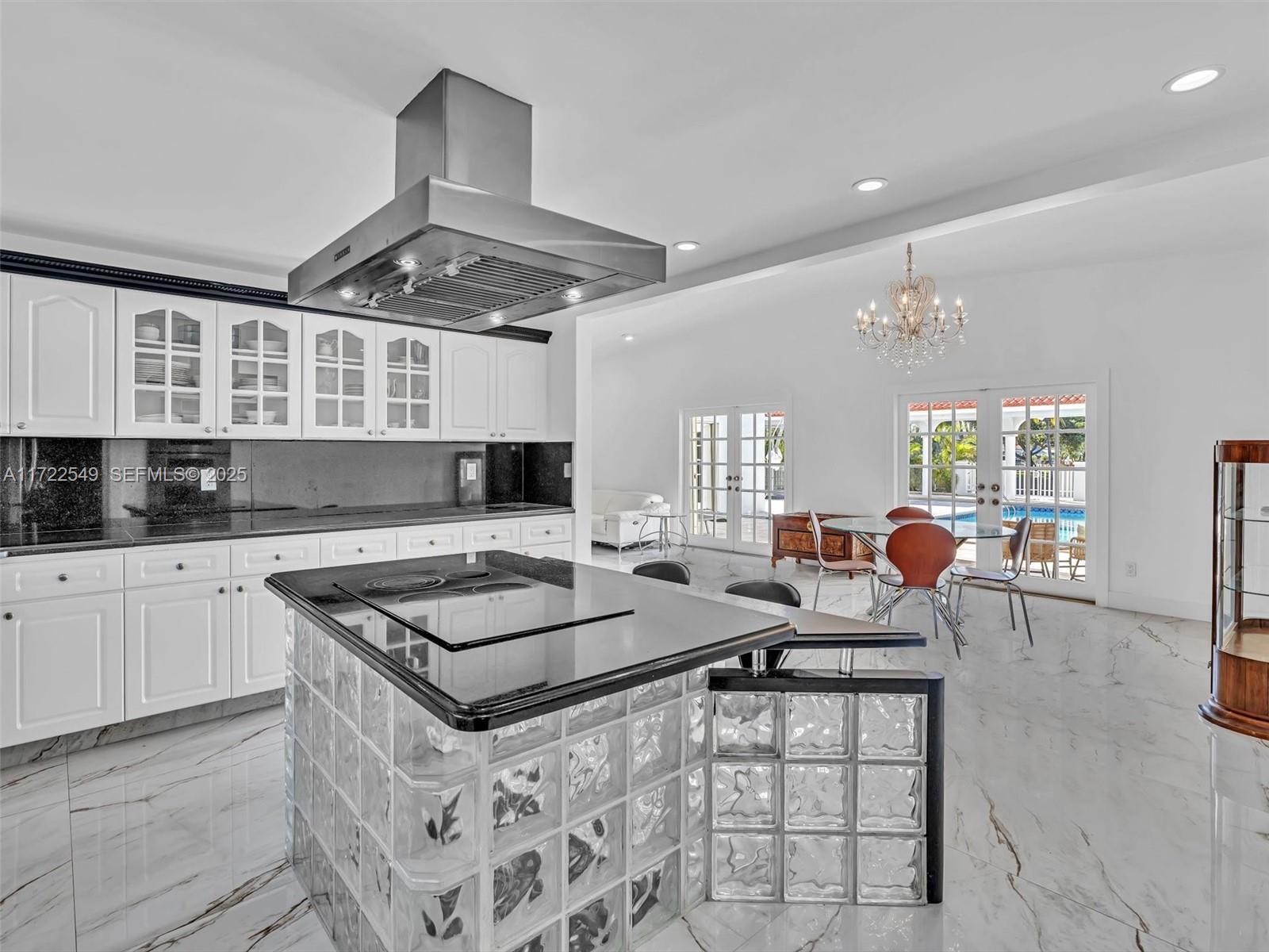 12904 Banyan Road North Miami, FL 33181 - Photo 8 of 87 a kitchen with stainless steel appliances granite countertop a stove a sink dishwasher and white countertops with cabinets