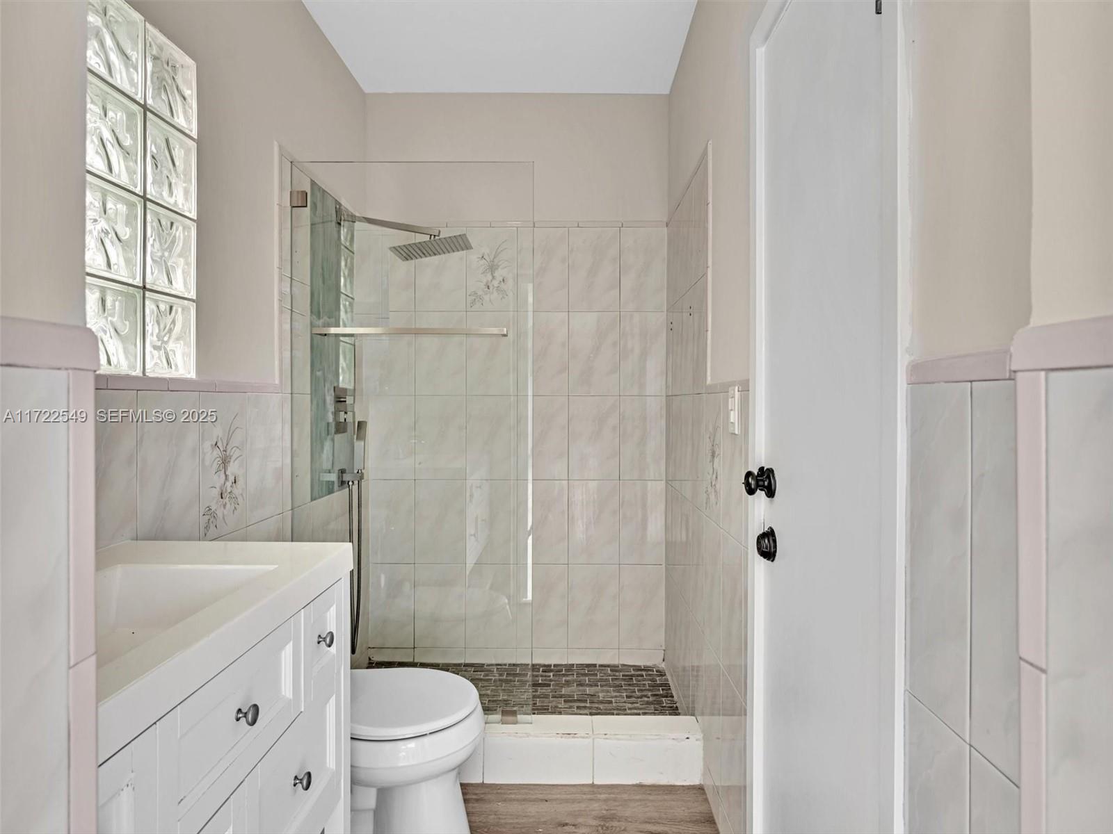 12904 Banyan Road North Miami, FL 33181 - Photo 81 of 87 a bathroom with a granite countertop sink a toilet and shower