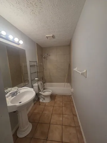 a bathroom with a sink a toilet and mirror
