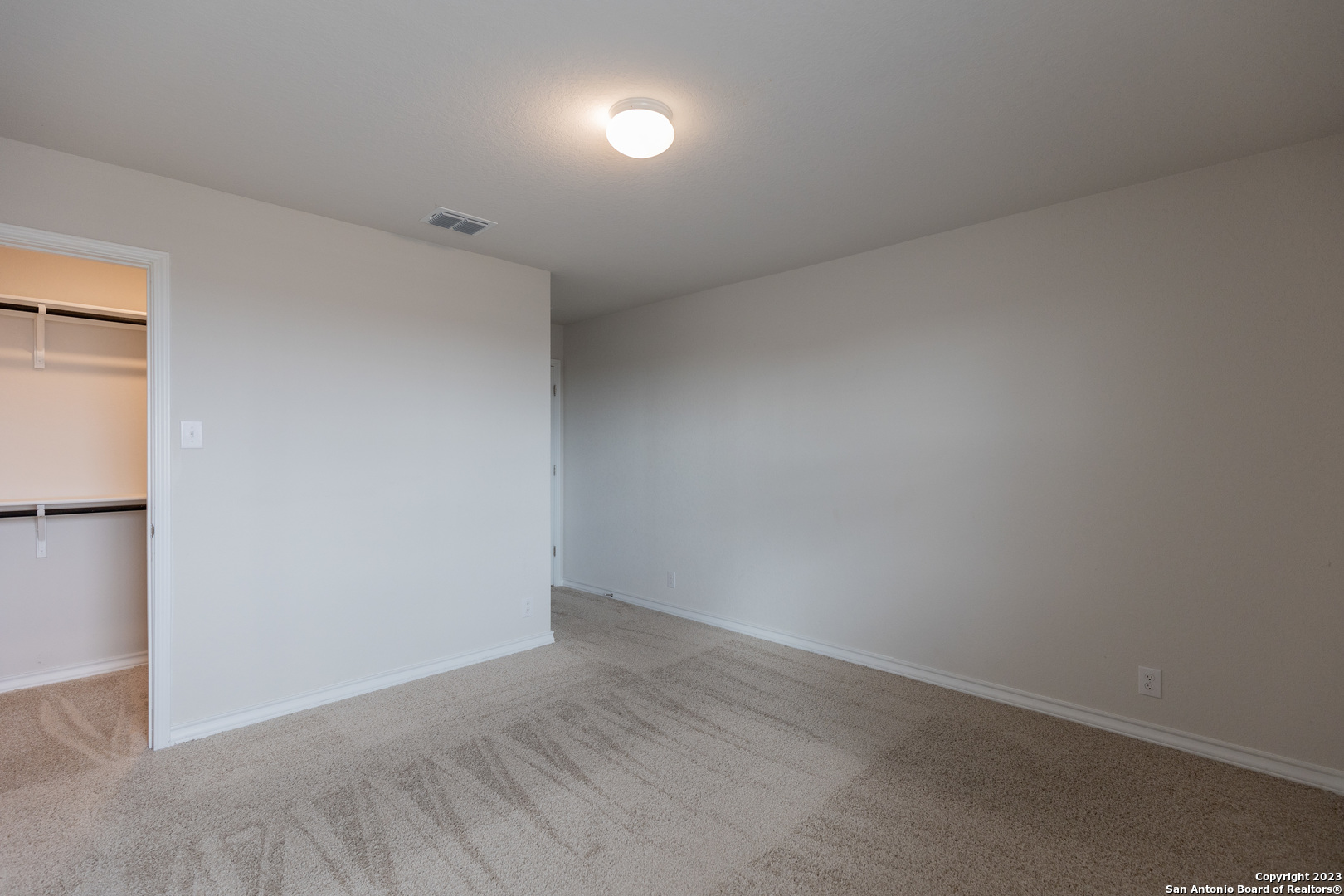 9819 Bratten Rise San Antonio, TX 78254 - Photo 25 of 37 an empty room with wooden floor and windows