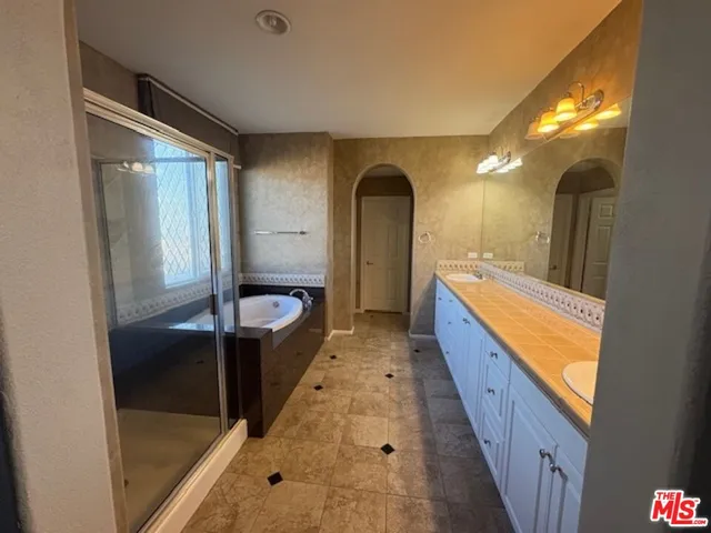 a bathroom with a double vanity sink and a mirror