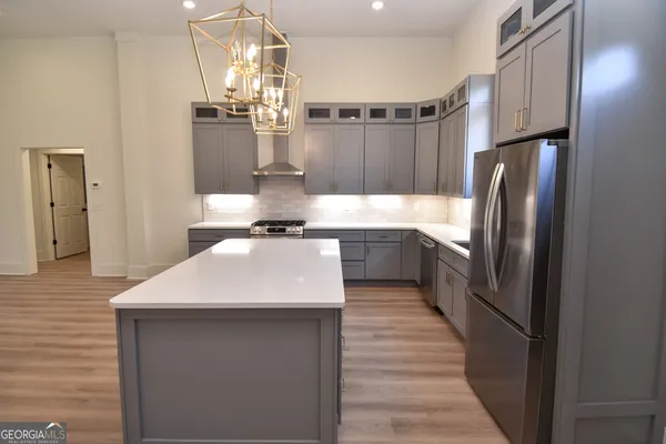 a view of a room with wooden floor and staircase