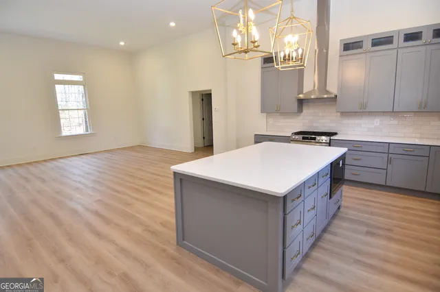 an empty room with wooden floor and a toilet