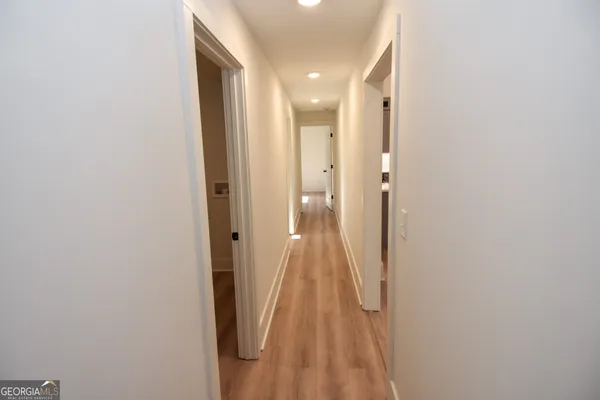 a view of a hallway with wooden floor