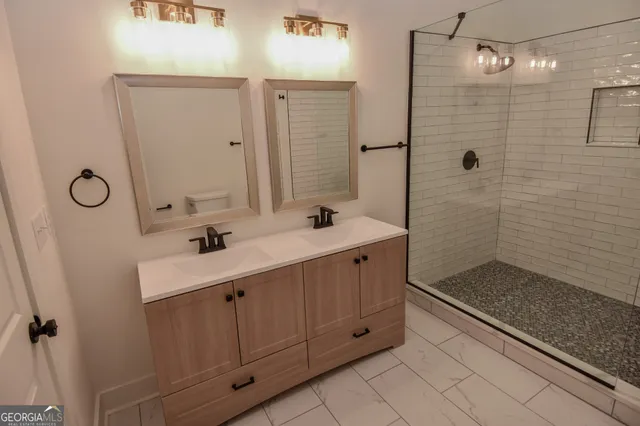 a view of a house with a yard chairs and iron fence