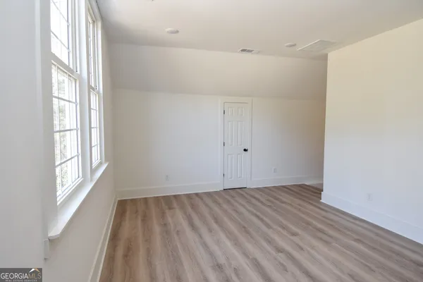 a view of a house with backyard and a tree