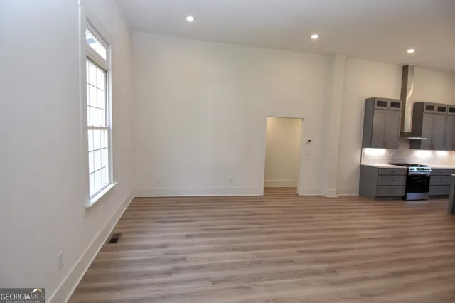 a large kitchen with granite countertop a sink and a refrigerator