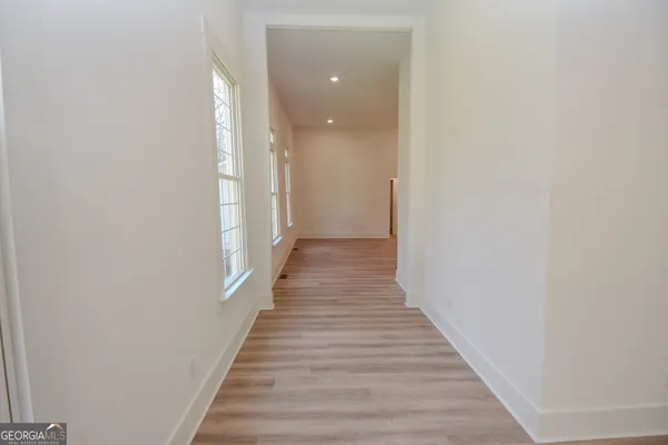 a large kitchen with granite countertop a sink and a refrigerator