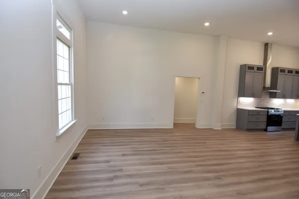 a kitchen with kitchen island a counter top space cabinets and stainless steel appliances