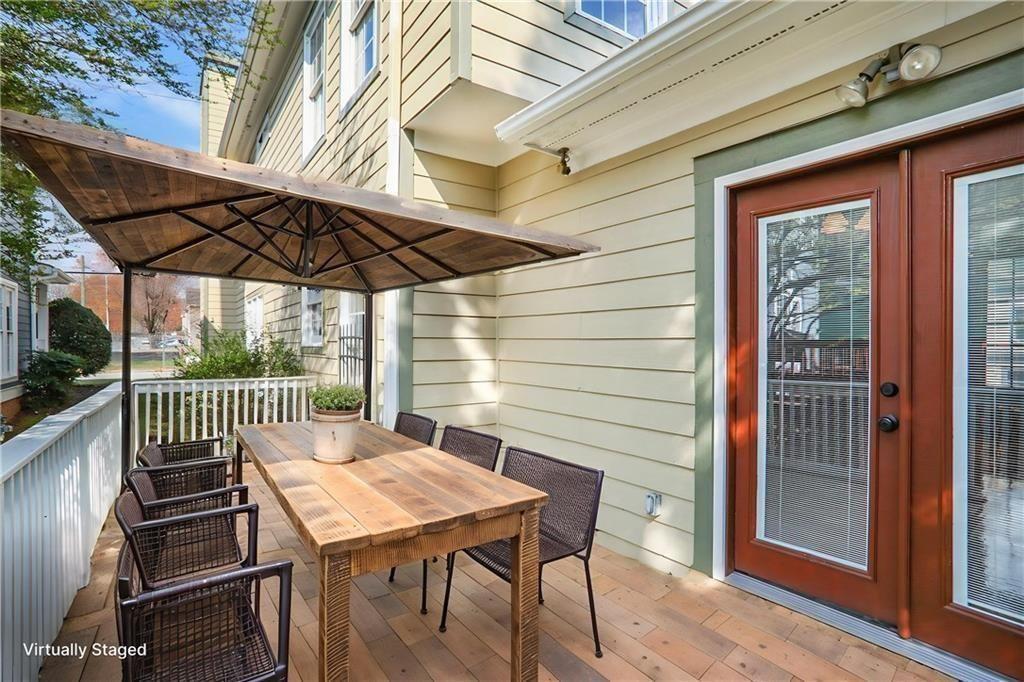 484 Martin Street Southeast Atlanta, GA 30312 - Photo 13 of 19 a view of a patio with table and chairs under an umbrella with a small yard