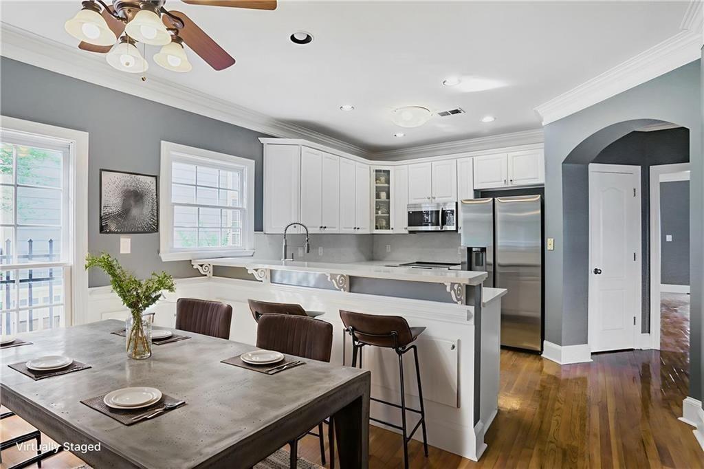 484 Martin Street Southeast Atlanta, GA 30312 - Photo 2 of 19 a kitchen with a table chairs refrigerator and cabinets