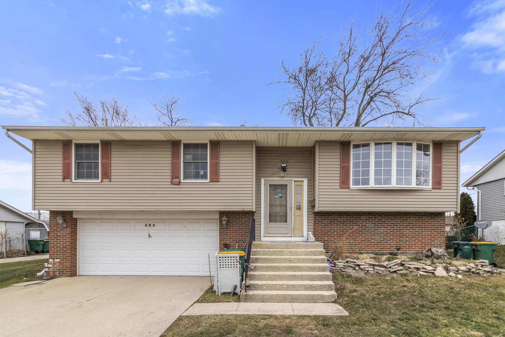 620 West Romeo Road Romeoville, IL 60446 - Photo 1 of 16 a front view of a house with a garden