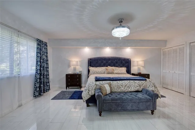 a living room with furniture and a floor to ceiling window