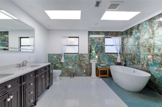 a front view of house with yard and trees in the background