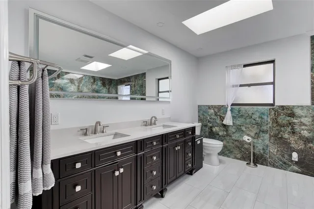 an aerial view of a house with swimming pool and big yard