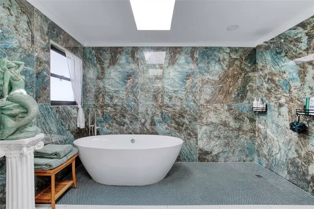 an aerial view of a house with a yard and swimming pool