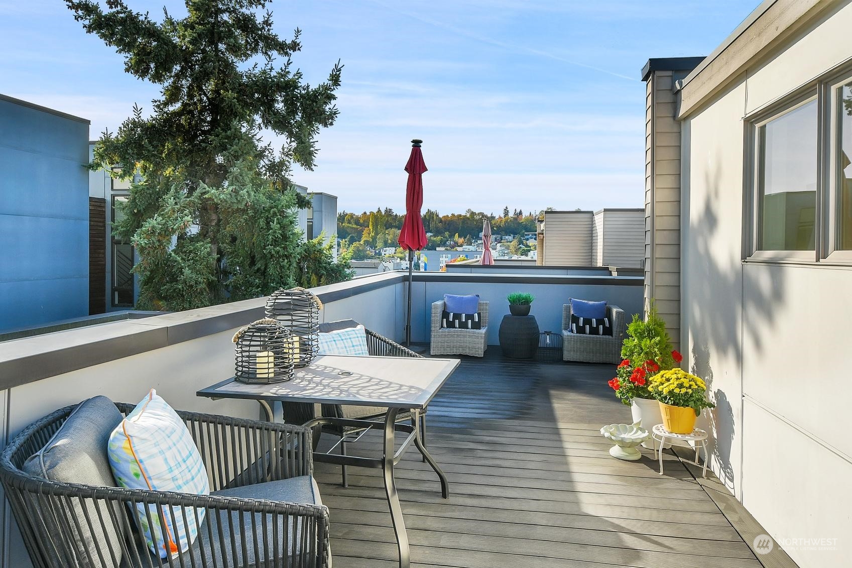 1907 25th Avenue South, Unit A Seattle, WA 98144 - Photo 18 of 23 a balcony with wooden floor table and chairs