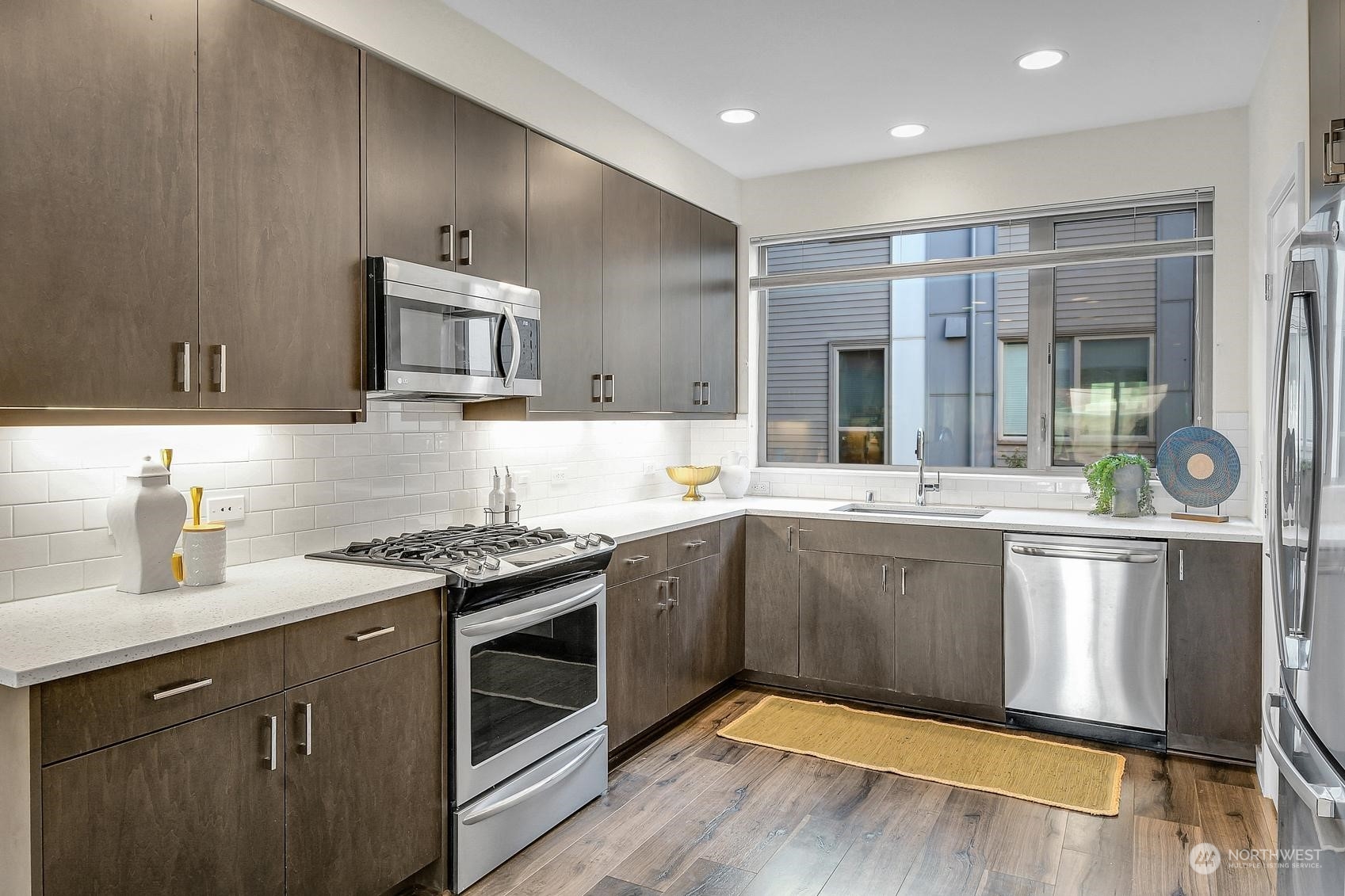 1907 25th Avenue South, Unit A Seattle, WA 98144 - Photo 8 of 23 a kitchen with stainless steel appliances granite countertop a stove and cabinets