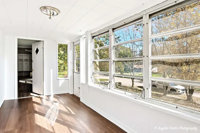 a view of a room with wooden floor and windows