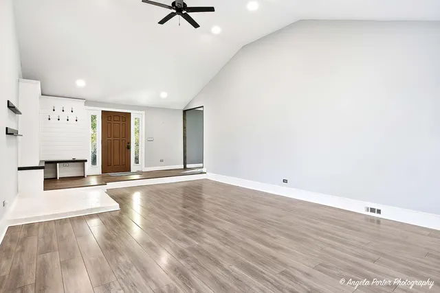 a view of a room with wooden floor and white walls