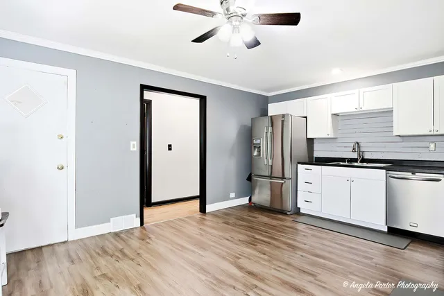 a kitchen with stainless steel appliances a refrigerator and a stove top oven