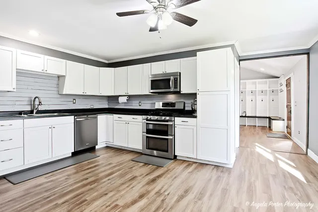 a kitchen with granite countertop a stove and a sink
