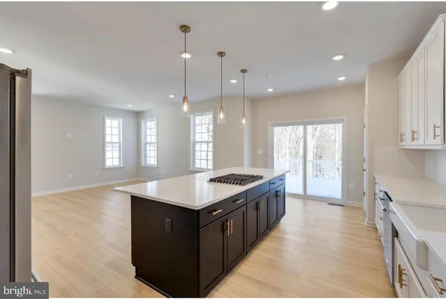 a kitchen with stainless steel appliances granite countertop a sink a counter top space and a window