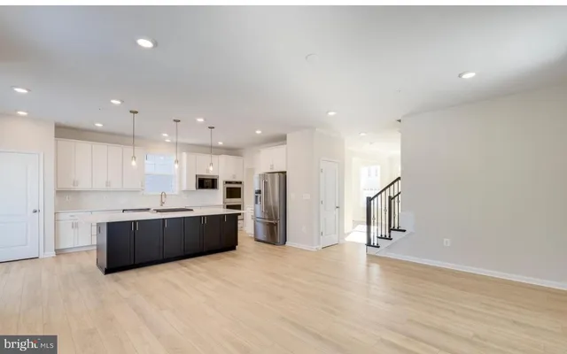 a large kitchen with a large counter top appliances and cabinets