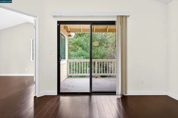 a view of a room with wooden floor and a window