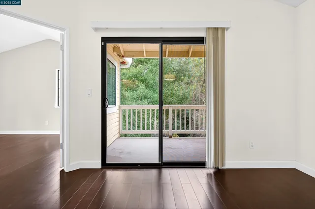 a view of a room with wooden floor and a window