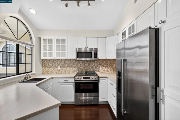 a kitchen with a refrigerator and a sink