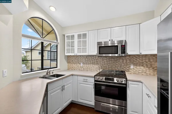 a kitchen with granite countertop a stove and a sink