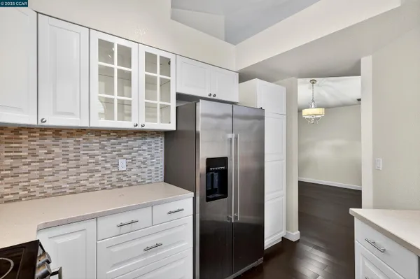 a kitchen with stainless steel appliances granite countertop a refrigerator and a sink