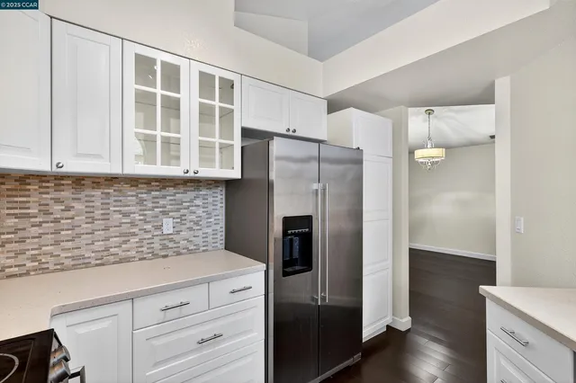 a kitchen with stainless steel appliances granite countertop a refrigerator and a sink