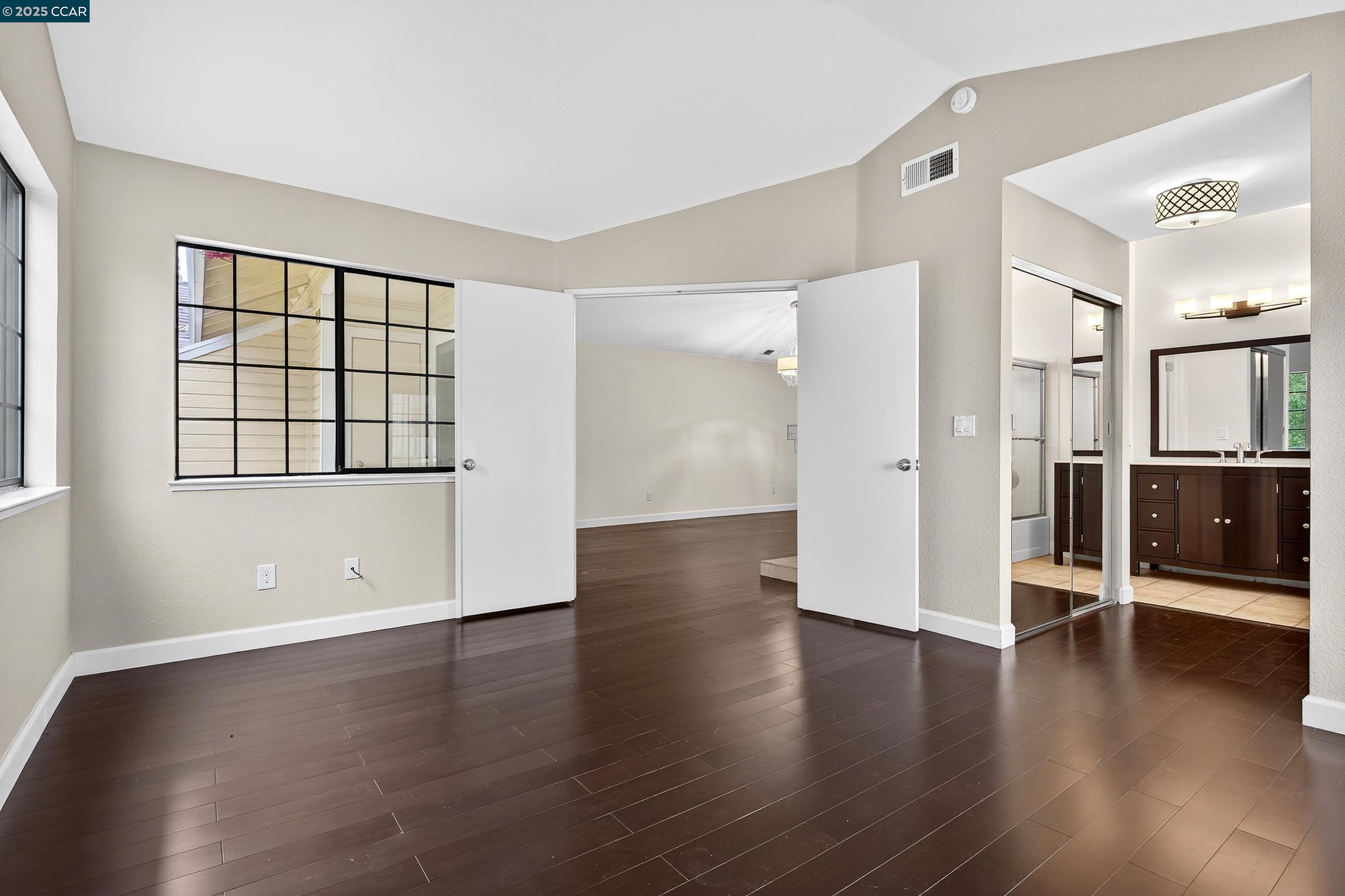 1202 Devonwood Hercules, CA 94547 - Photo 19 of 46 an empty room with wooden floor and windows